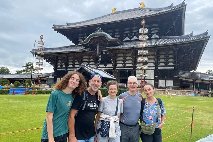 Licensed guide walking visitors through Nara Park on a private Nara day trip from Kyoto, Japan